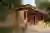 NaaV Studio Builds a Rammed Earth Restroom That Disappears into a Hyderabad Mango Grove