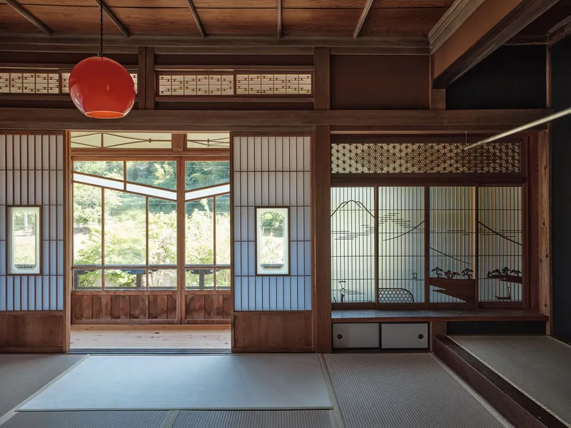 Tatami room with sliding screen doors opening to garden under coffered timber ceiling