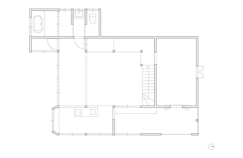 Floor plan drawing showing bathroom suite, central staircase and open living spaces