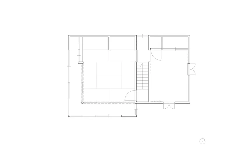 Upper floor plan drawing with central staircase connecting bedroom and secondary rooms
