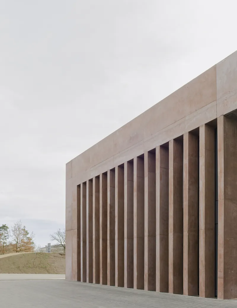 Close view of the vertical concrete fin system framing deep shadow recesses in overcast light