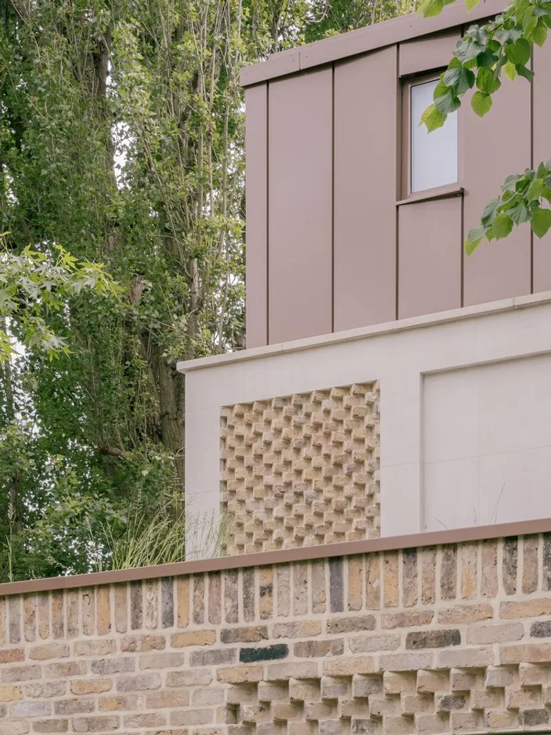 Facade layering showing brick base with basketweave panel and timber-clad upper storey framed by trees