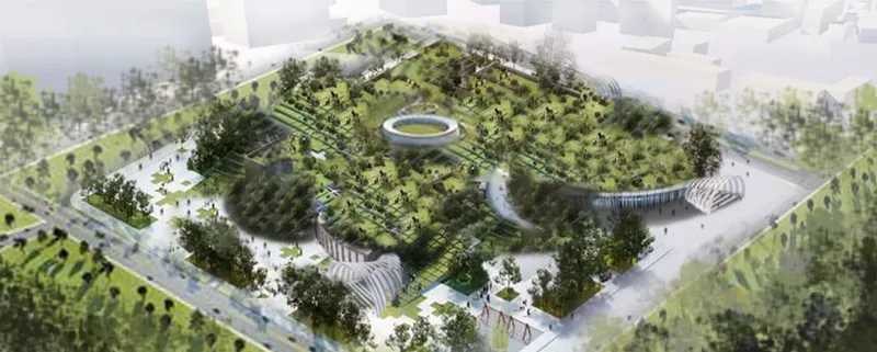 Aerial view of the terraced green roof rising above the surrounding urban context with trees