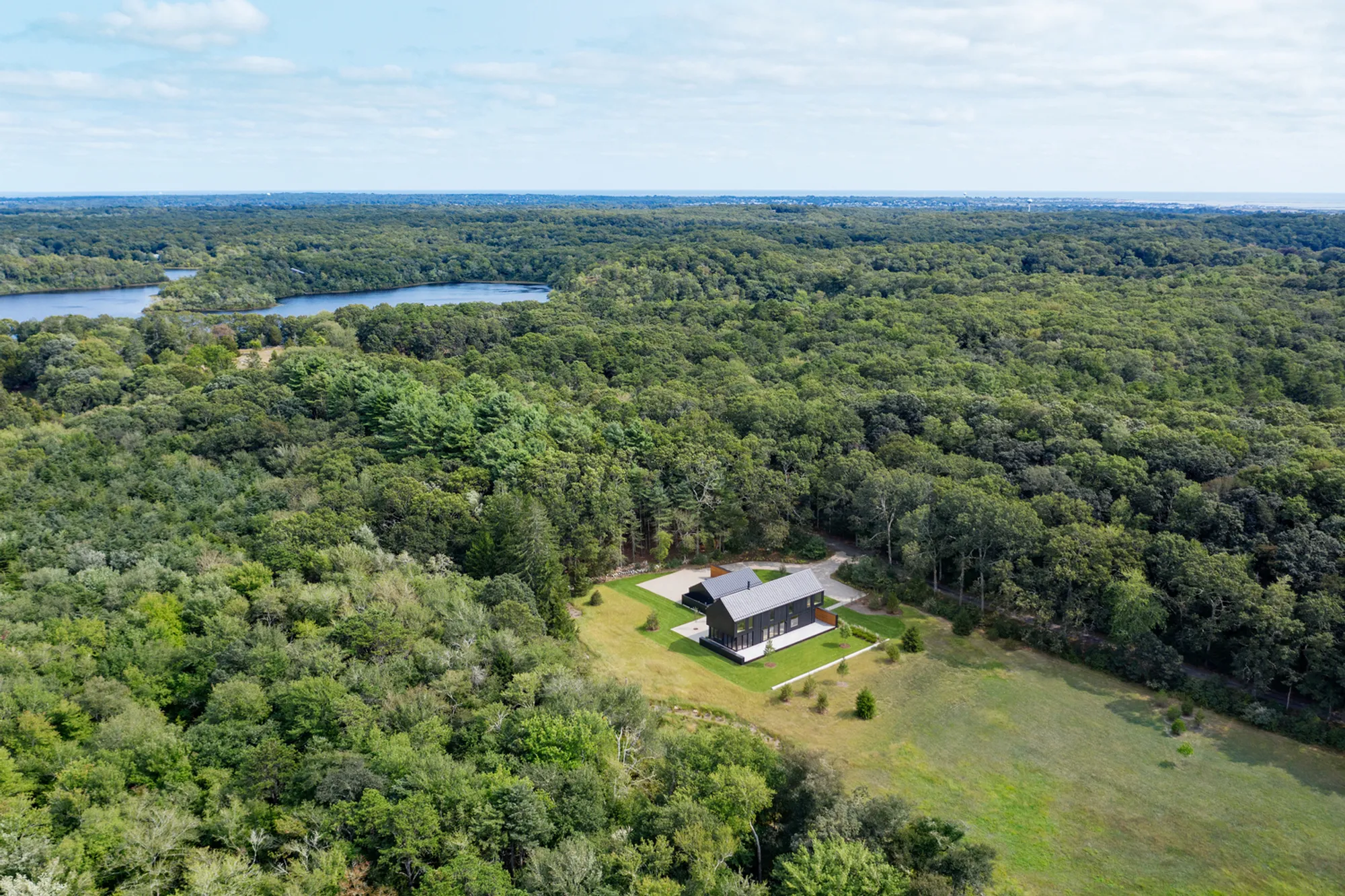Birdseye Anchors a Cedar and Plaster Farmhouse to the Edge of a Rhode Island Meadow