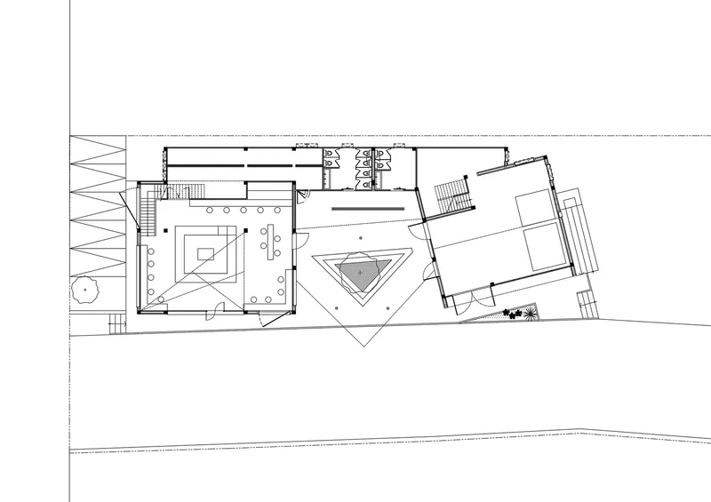 Ground floor plan showing spaces arranged around triangular courtyard with grid structure along left edge