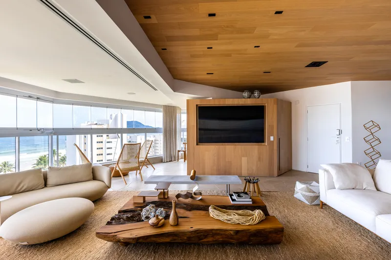 Living room with floor-to-ceiling glazing overlooking the ocean and distant mountains