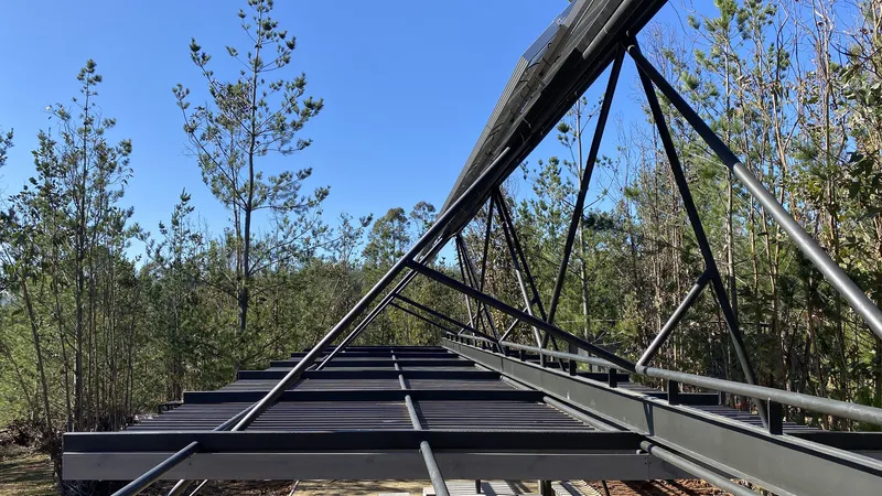Close-up of the corrugated metal roof deck with exposed steel beams and angular supports