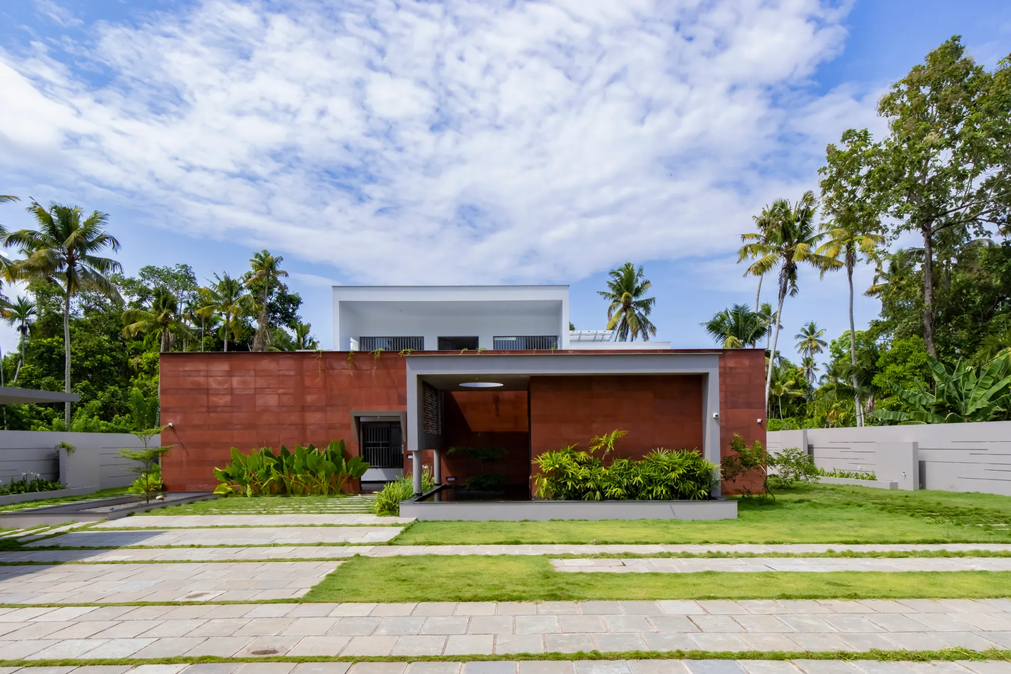 Red Wall Residence: A Modern Tropical Retreat by i2a Architects Studio