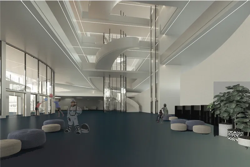 Double-height interior lobby with suspended glass elevator cores and circular soft seating on blue carpet