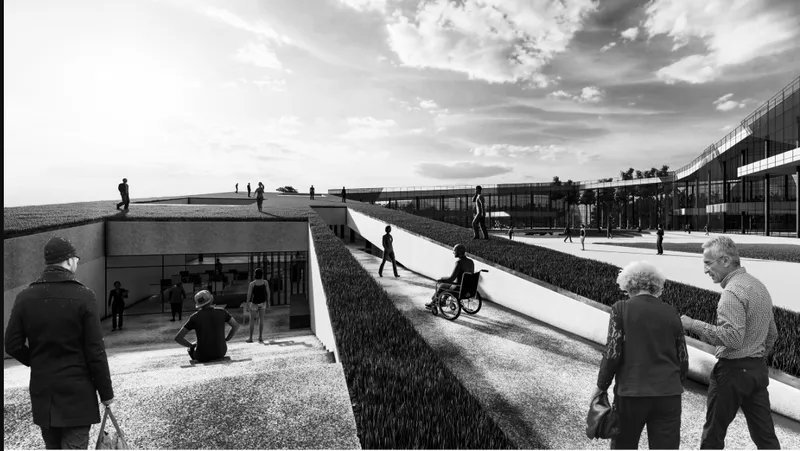 Ramped plaza with planted berms leading to sunken entrance and horizontal glazed building under cloudy sky