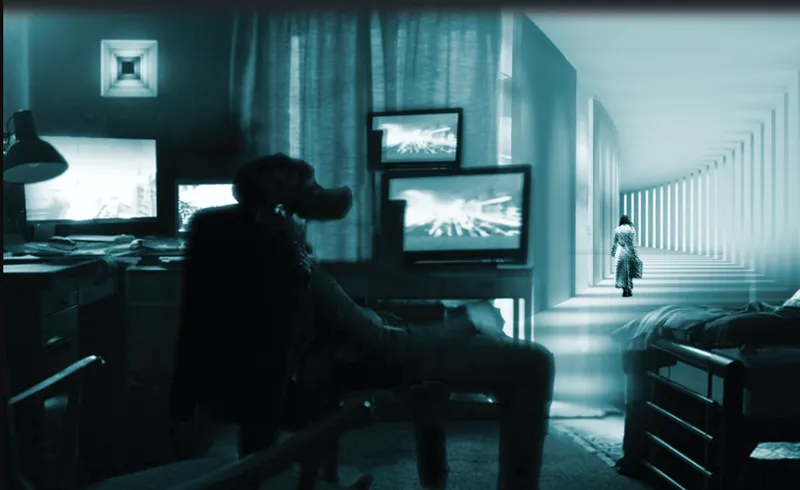 Interior workspace with multiple screens and a figure seated, alongside a corridor with rhythmic vertical light bands