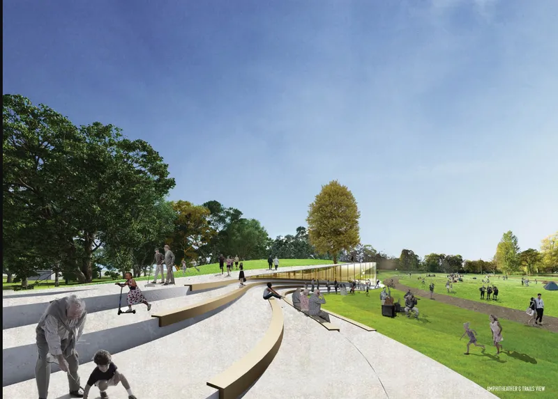 Tiered concrete amphitheater steps descending into a park landscape with children playing and mature trees beyond