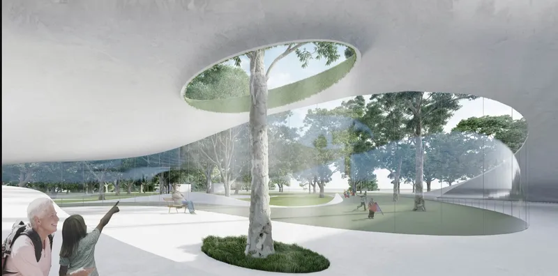 Interior view with circular skylights framing tree trunks that penetrate the white curved ceiling planes