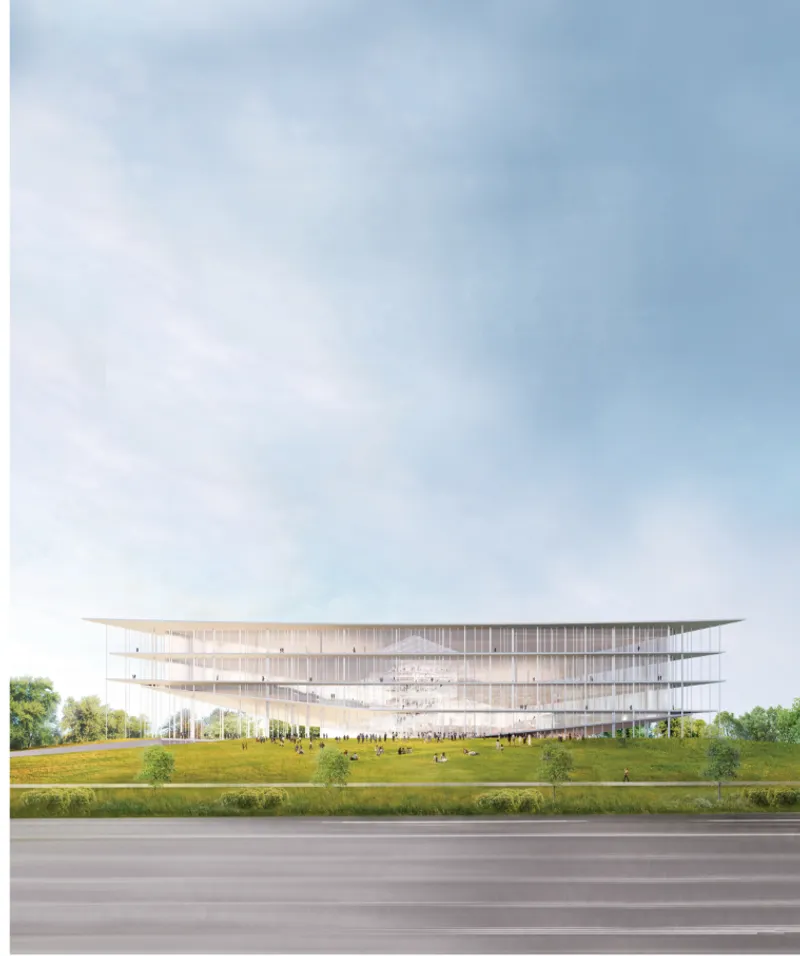 Long view of the elevated transparent volume on columns above a sloping lawn and roadway