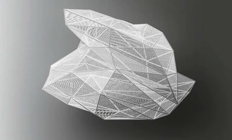 Physical model of a faceted triangulated shell structure with varying surface textures on a grey background