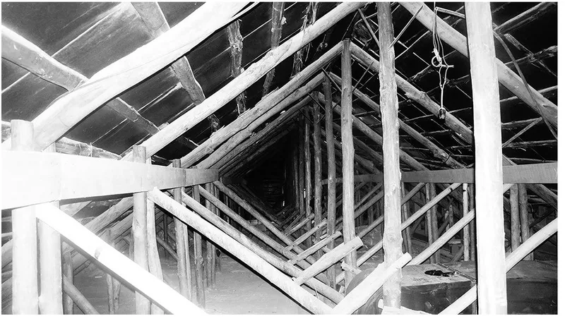 Upward view of exposed timber roof framing and diagonal bracing in unfinished attic space