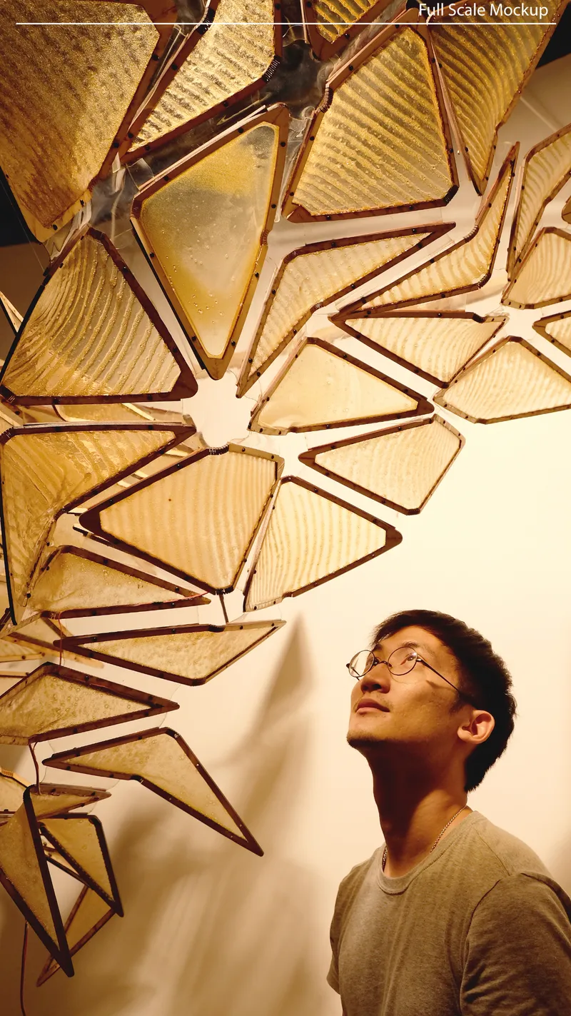 Upward view of translucent triangular panels radiating from a central point with a person looking up