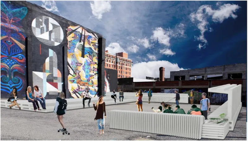 Public plaza with white modular seating elements and pedestrians beneath murals on brick party walls