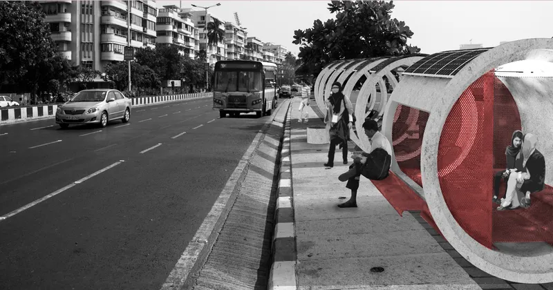 Row of cylindrical bus shelters with curved solar panel roofs and red perforated end walls along a busy street