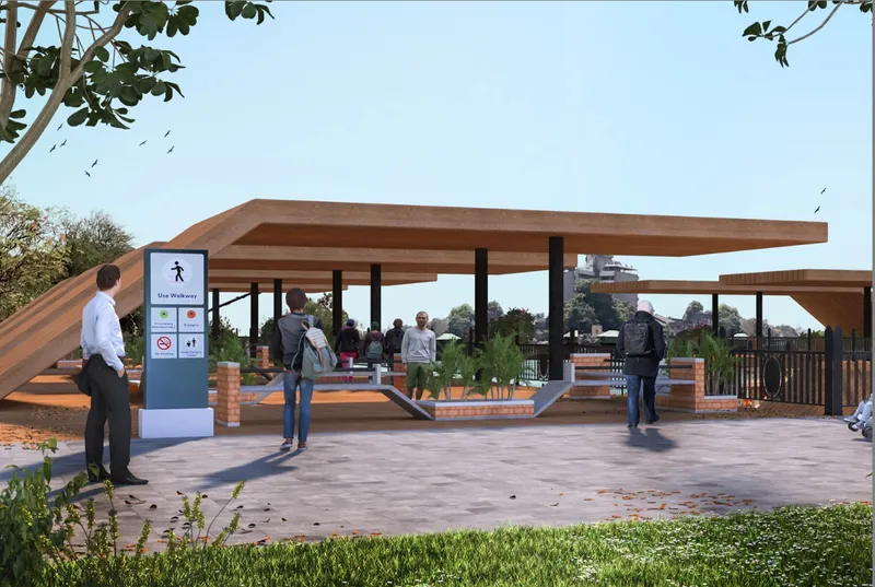Open timber pavilion with sloped roof supported by black columns overlooking a paved plaza
