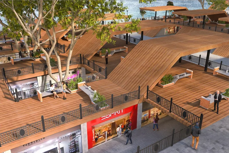 Aerial view of undulating timber roof planes covering retail storefronts and planted courtyards below
