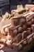 The image showcases a stack of red bricks, each featuring two prominent circular elements. The brick