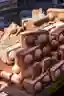 The image showcases a stack of red bricks, each featuring two prominent circular elements. The brick