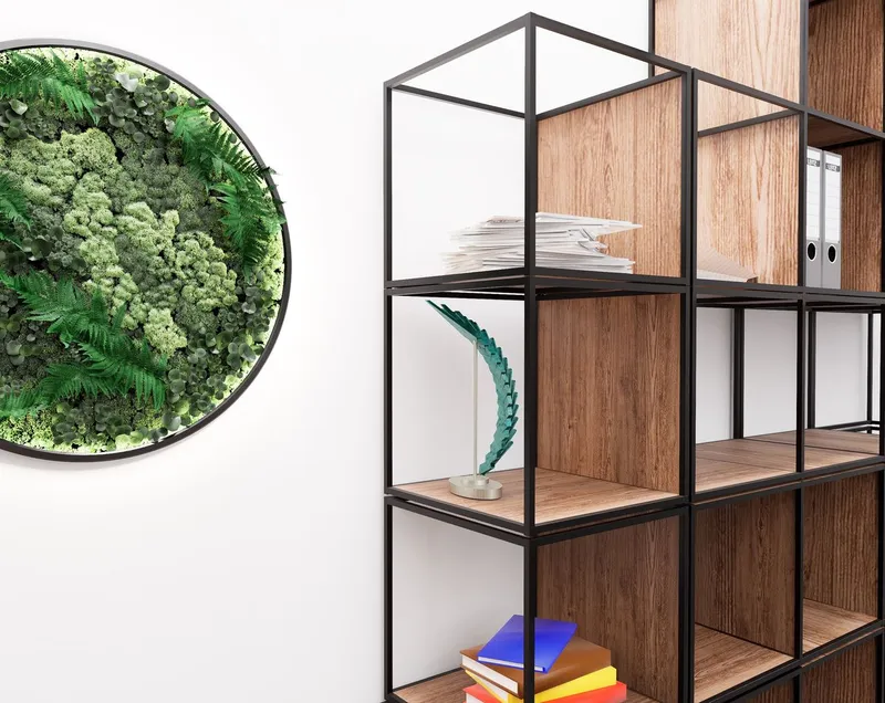 Teal wing sculpture displayed on a black steel shelving unit beside a circular planter