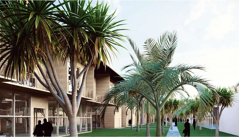 Exterior colonnade with stone columns framing a planted lawn under an overcast sky