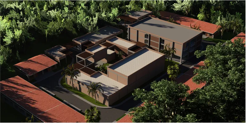 Oblique aerial view of the clustered volumes with terra cotta tile roofs and tropical vegetation
