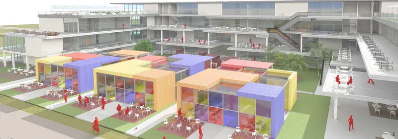 Aerial view of clustered colored pavilions arranged across the green courtyard with surrounding buildings