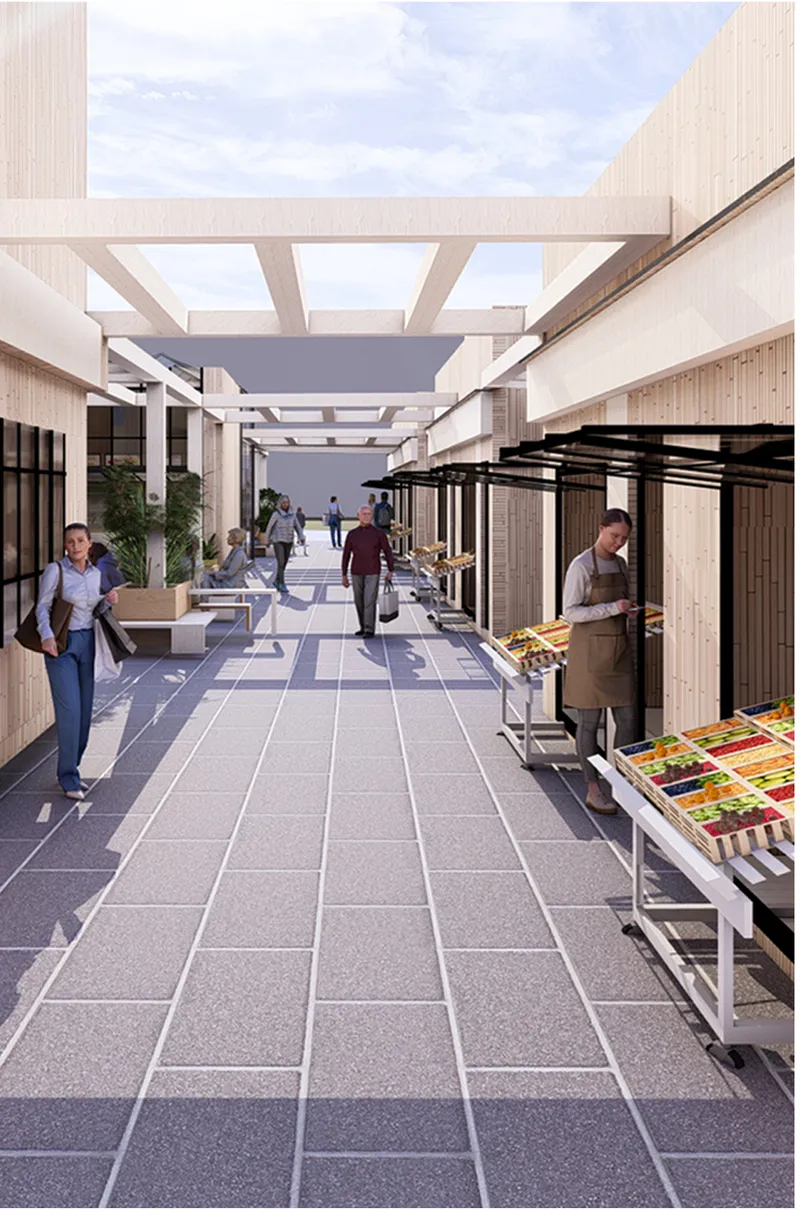 Linear market corridor with overhead beams, vendor stalls on the right, and pedestrians walking through