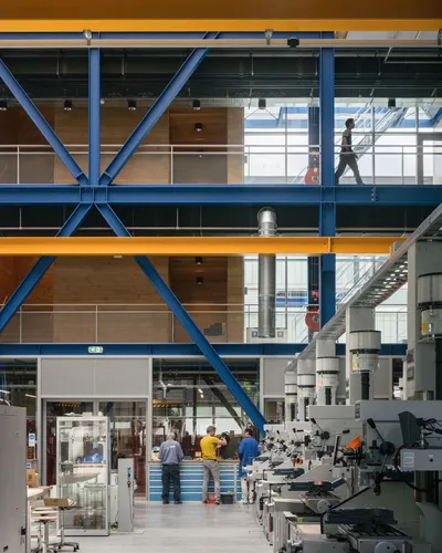 This architectural image showcases the interior of a modern industrial facility. The space features 