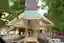 This architectural image showcases a contemporary pavilion with a wooden frame and geometric design.