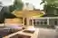 This architectural image showcases a contemporary pavilion with a wooden structure and a colorful ca