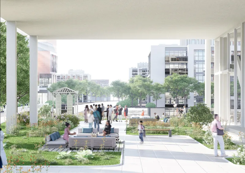 Elevated courtyard with planted beds and benches framed by white columns overlooking surrounding buildings