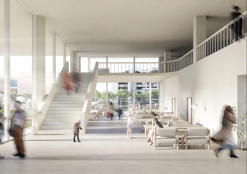 Double-height foyer with wide central staircase leading to mezzanine balcony and floor-to-ceiling glazing