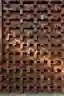 The image showcases a brick facade with a distinctive openwork pattern. The bricks are arranged in a