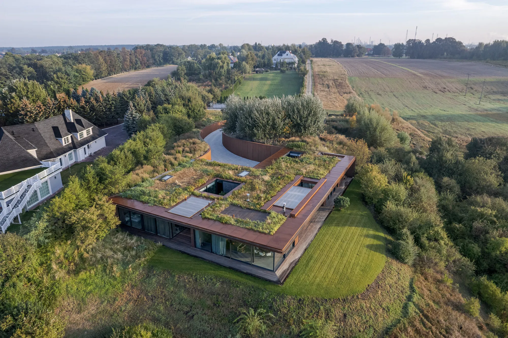 House in the Slope: A Modern Riverside Refuge by 77 Studio Architecture