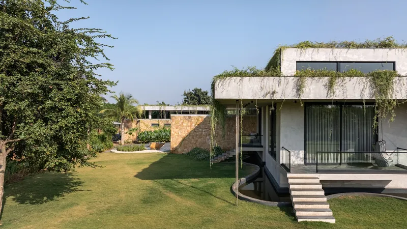 Concrete volume with planted rooftop terrace and glass walls overlooking curved lawn and reflecting pool