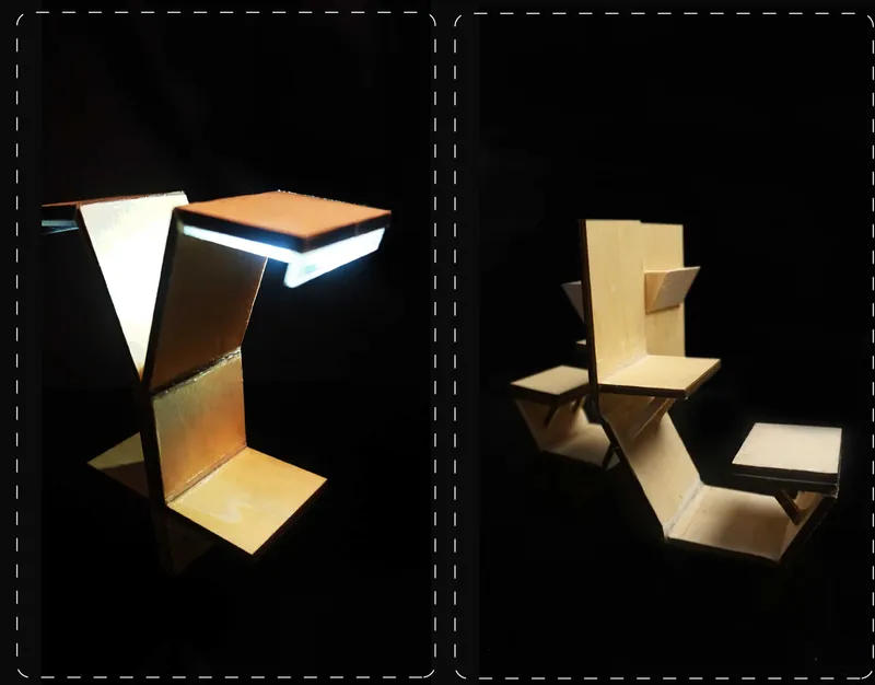 Physical study models of the folding chair and table units lit against black backdrop