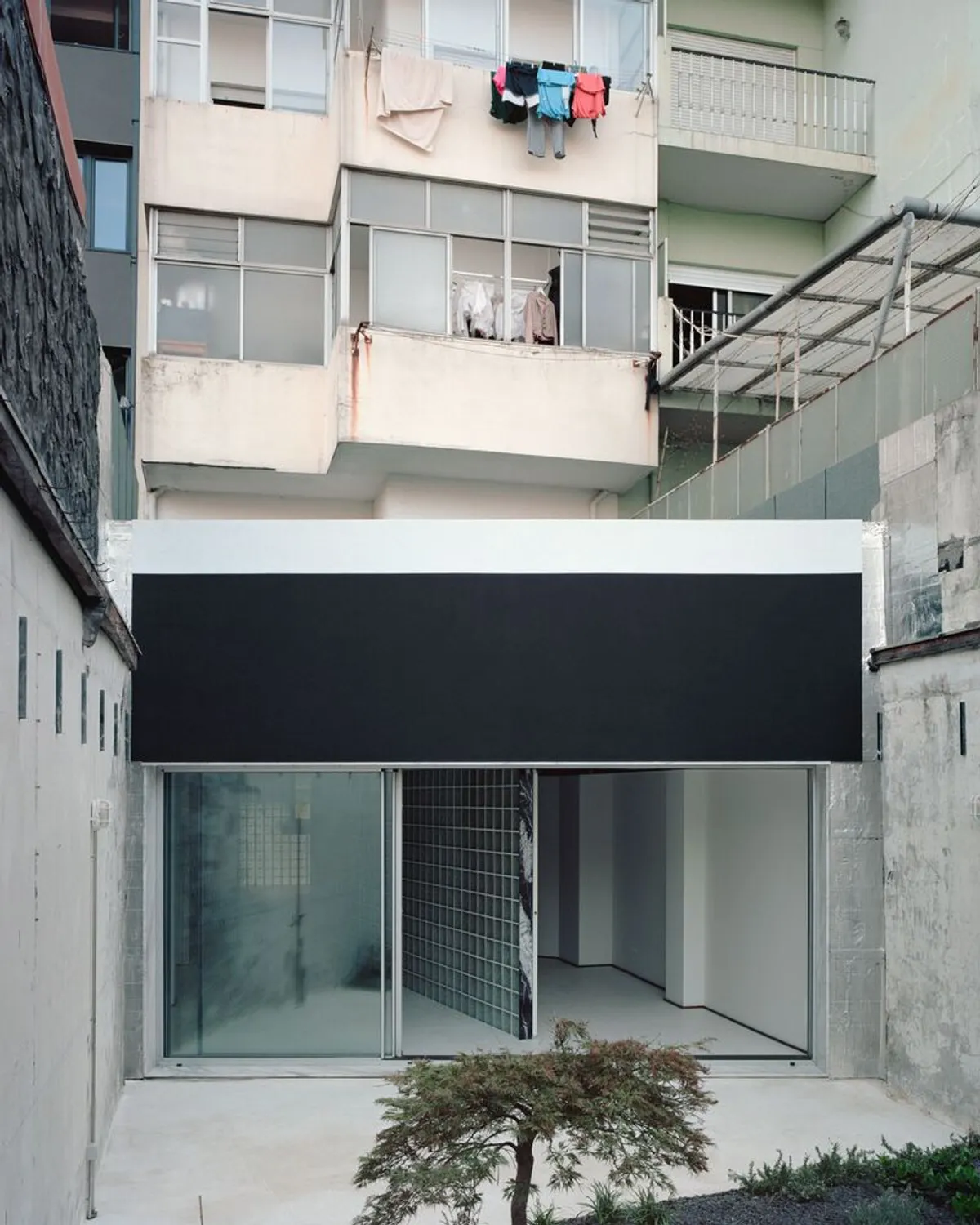 Oasis Under a Building by fala – Innovative Glass House in Porto, Portugal