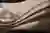 The image showcases a close-up of a draped fabric with a textured surface. The interplay of light an