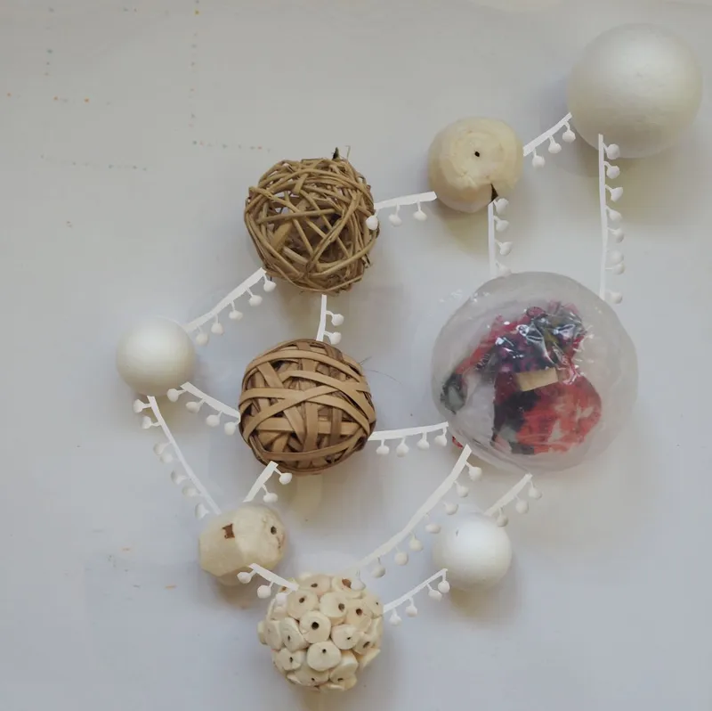 Top-down view of a study model with woven spheres and white structural frames on a white surface