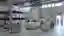 This image showcases the interior of a large industrial warehouse, characterized by its high ceiling