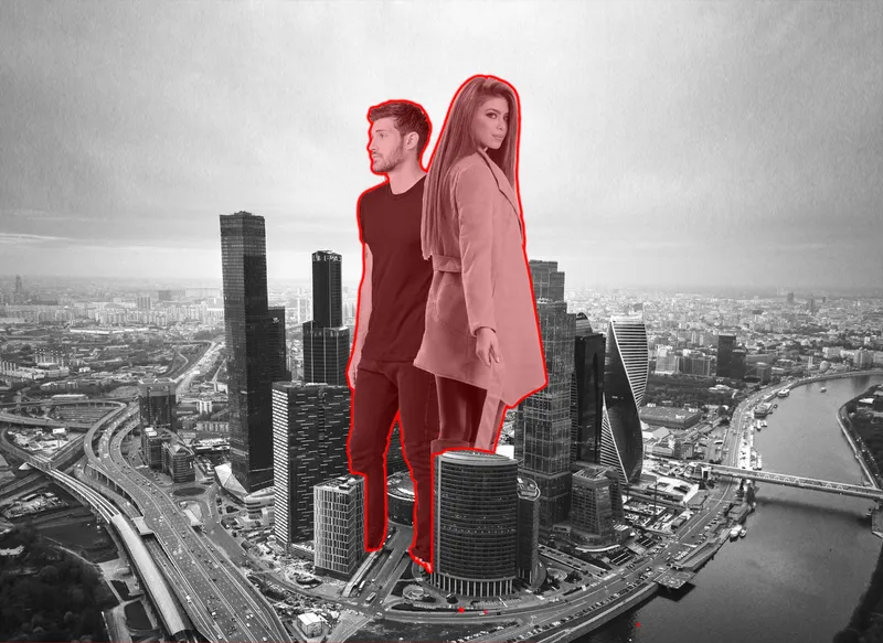 Aerial photograph of the tower district with two figures composited at colossal scale over the waterfront