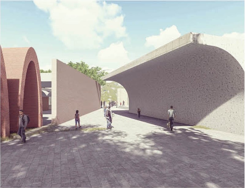 Barrel-vaulted passage with rough concrete walls connecting two courtyards as people walk through dappled sunlight