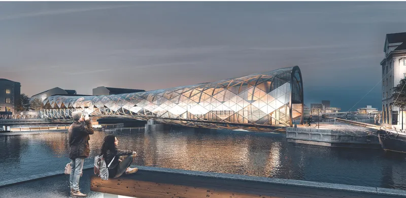 Illuminated triangular glass facade of the bridge reflected in the calm water at dusk