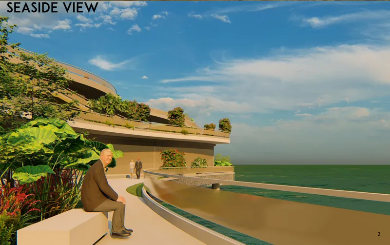 Exterior terrace overlooking the ocean with planted beds and seated figure under blue sky