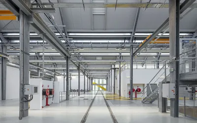 This architectural image showcases the interior of an industrial building, likely a factory or wareh